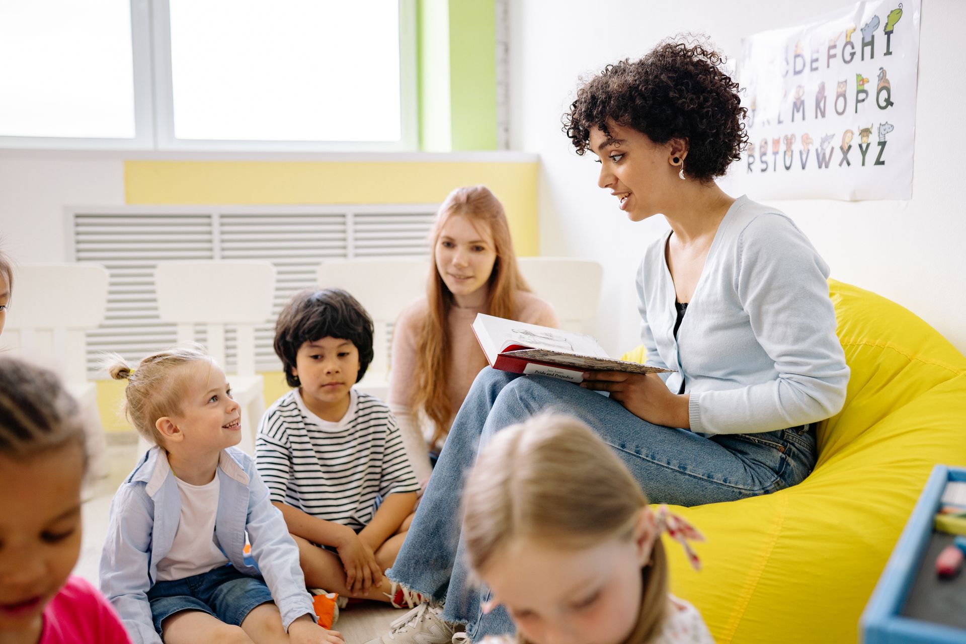 Residential care professional engaging children in a group activity